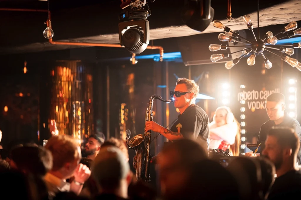 Saxophonist at a level 27 party fitting the global nightclub ranking standards